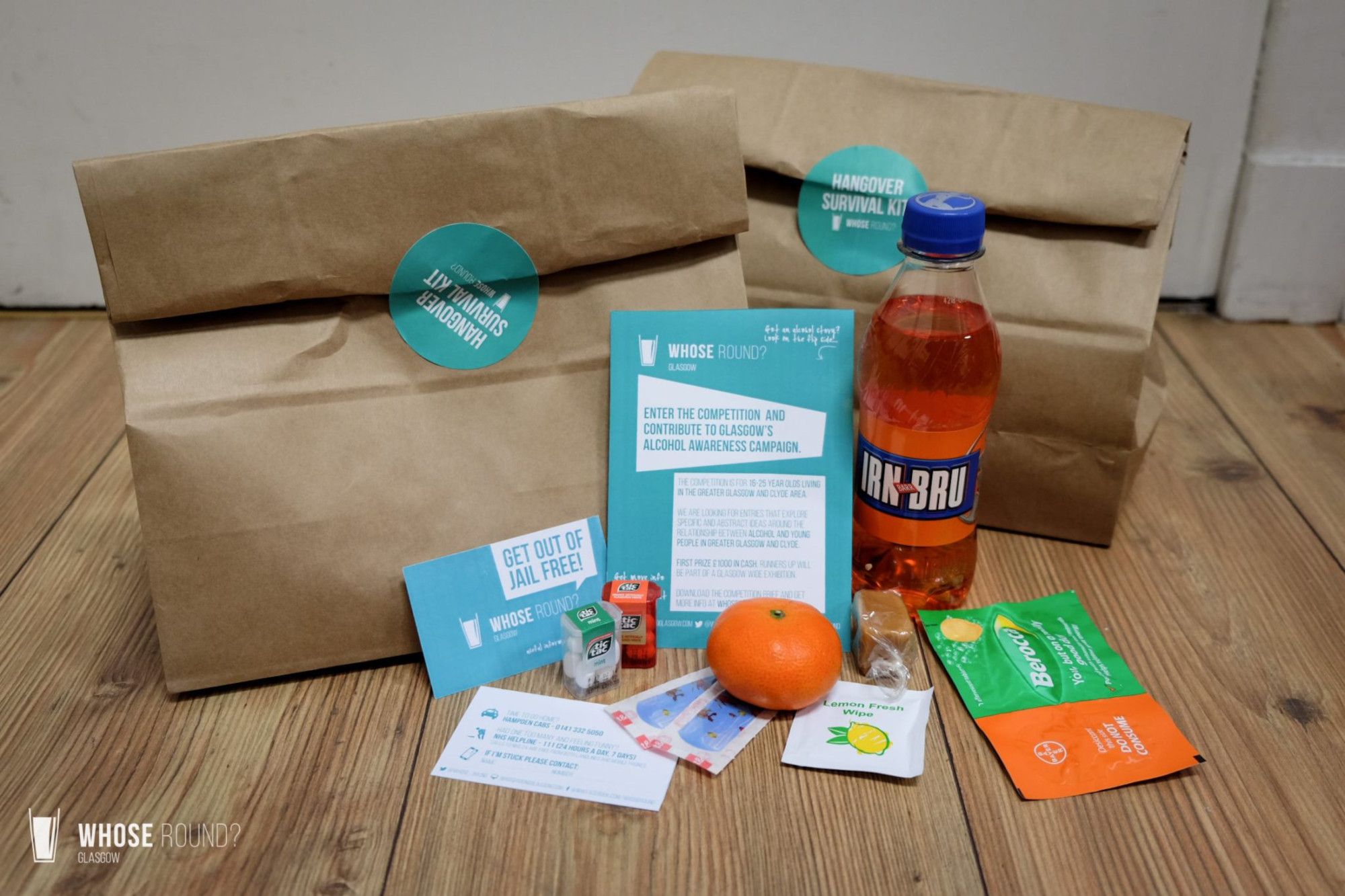 Drinks and foods in front a brown paper bags constituting hangover survival kits
